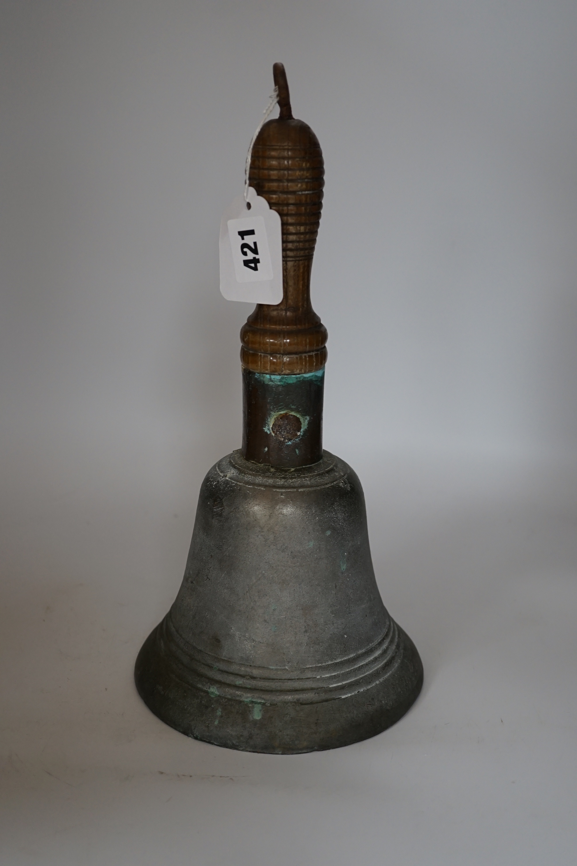 A bronze handbell with wooden handle, 31cm